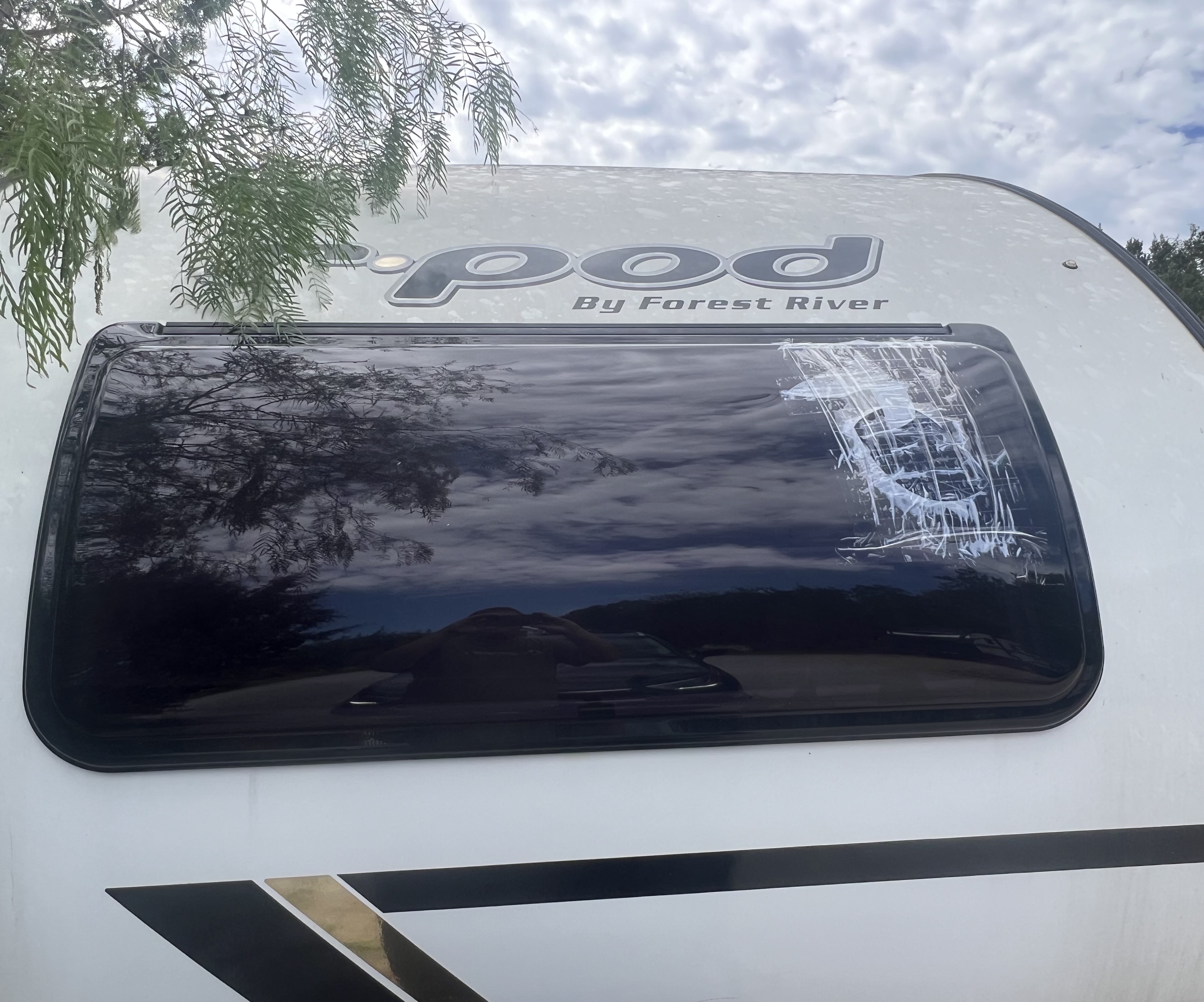 RV window damage photographed for insurance documentation — visible crack and seal condition documented at the frame perimeter before repair begins — Boss Bull Mobile RV Services